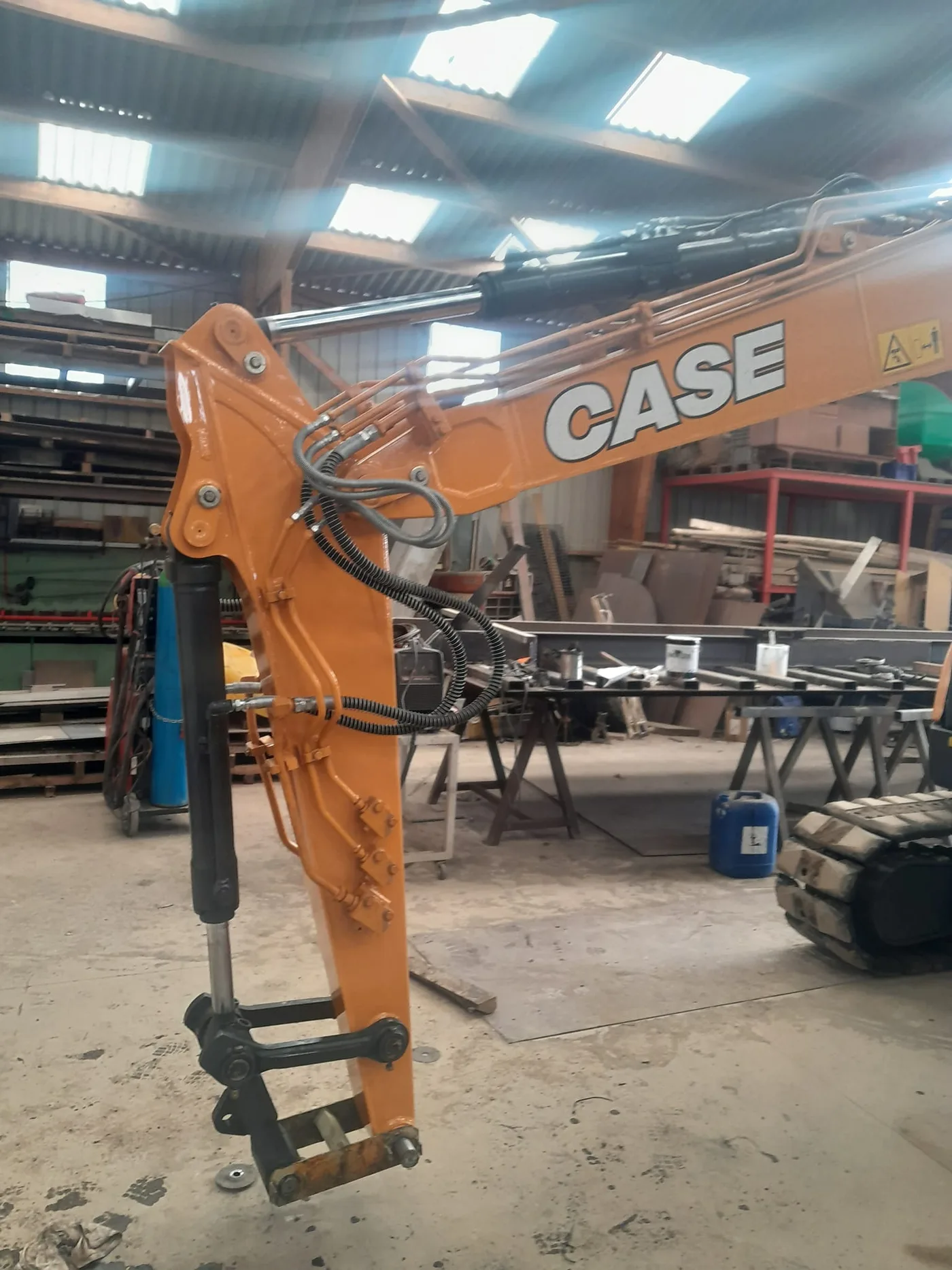 Modification de balancier de pelle Case